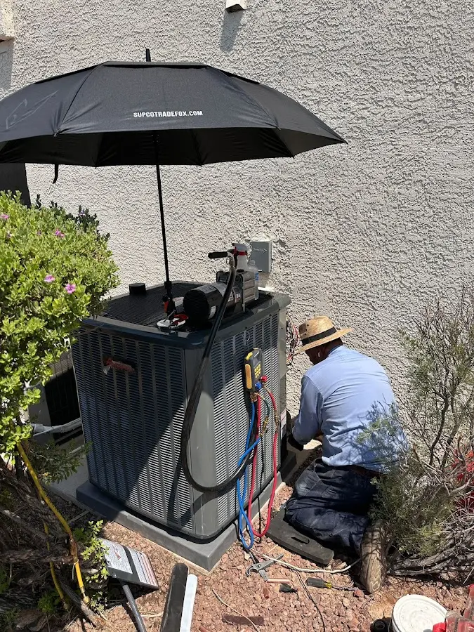 HVAC technician performing outdoor AC maintenance in Johnson City